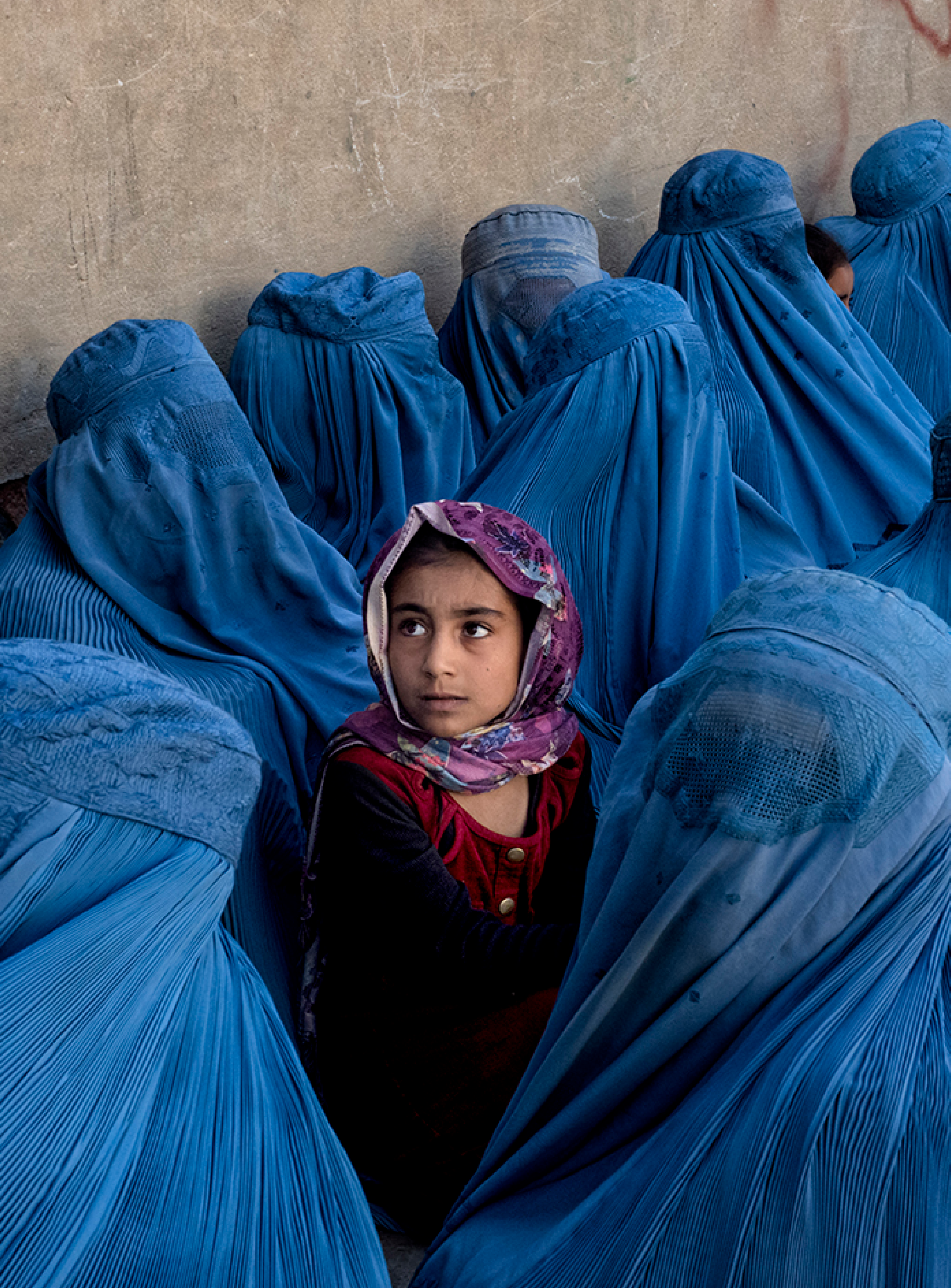 Retrato documental — mujeres con burqa y niña
